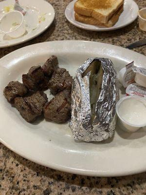 Beef tips and baked potatoes tender and juicy