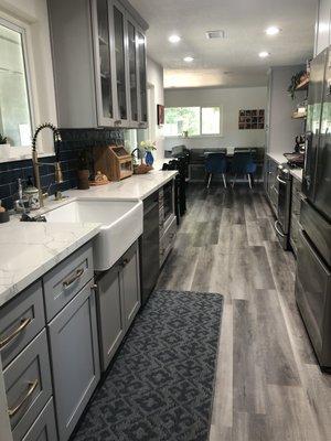 Quartz countertops and glass-doors on upper cabinets.