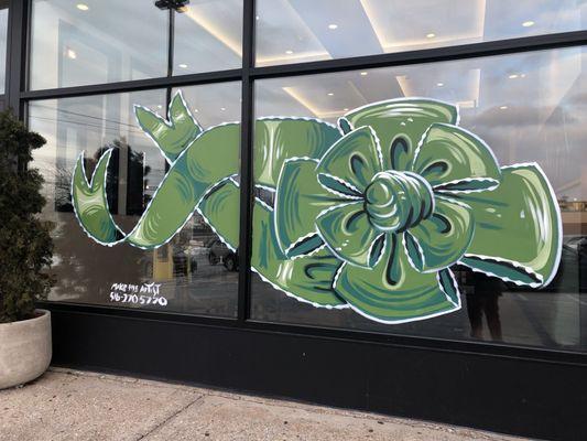 Beautiful green blue design bow in window done by Mike the artist