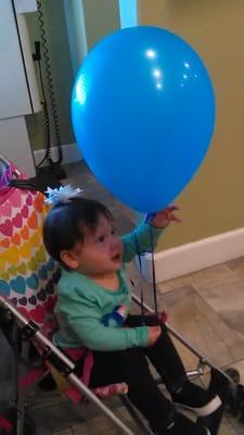 Loving her balloon after her teeth cleaning