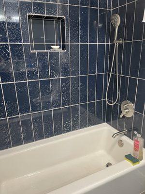 Cleaning a bathtub and wall with ECOS soap.