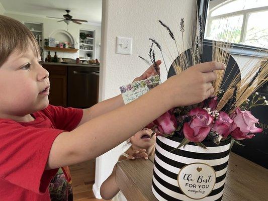 Our two grandchildren checking out mom's arrangement!  They loved it too.