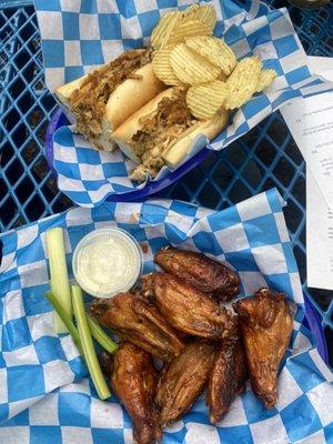 Sriracha honey chicken wings (front) and chicken cheesesteak (back)