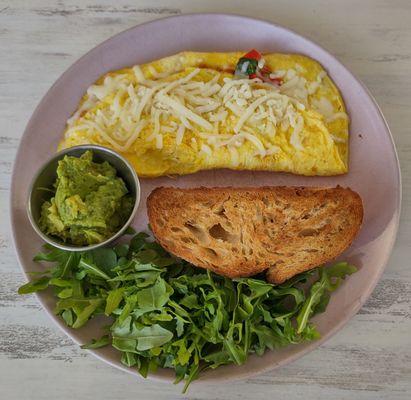 Veggie Omelette with toasted sourdough, mashed avocado, and arugula