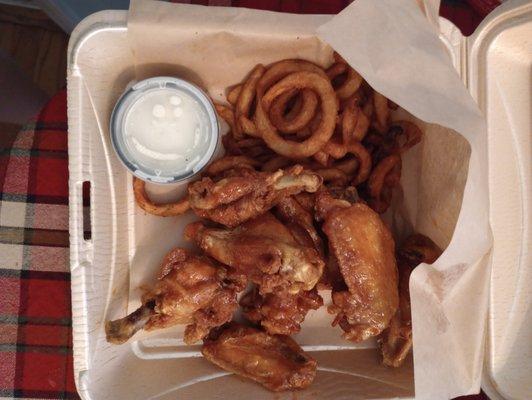 Honey Sriracha wings with curly fries and ranch dressing