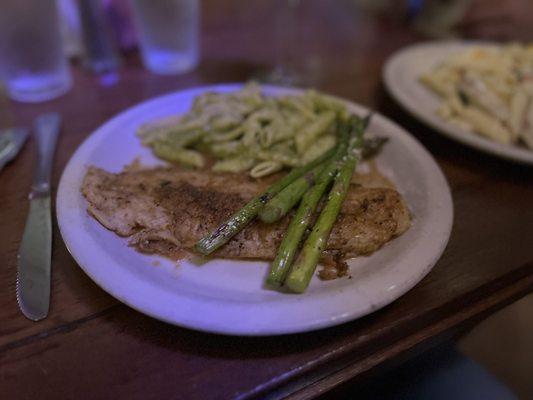 Baked white fish with grilled asparagus and penne, pasta and pesto sauce.