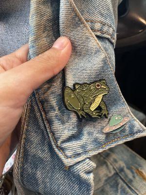 Frog pin on a blue jean jacket