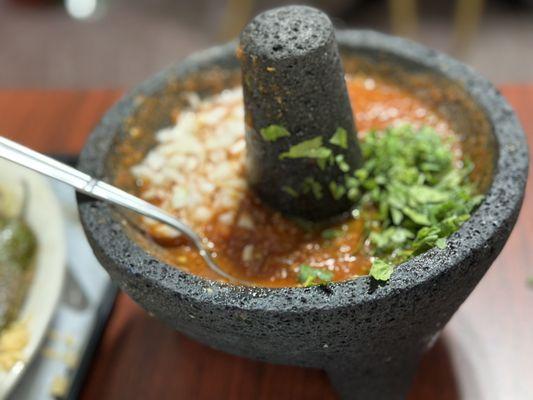 Made-to-order salsa served in a Molcajete