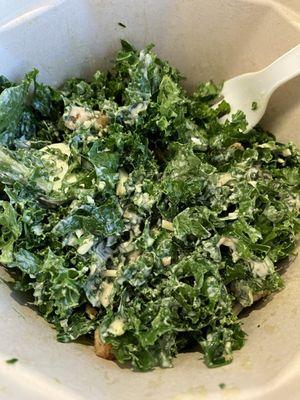 A partially eaten kale caesar salad for the Yelp records