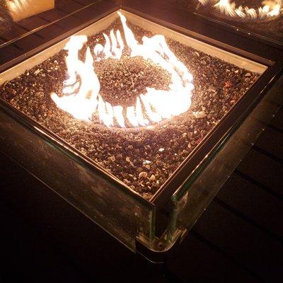 Firepit in the center of the table.