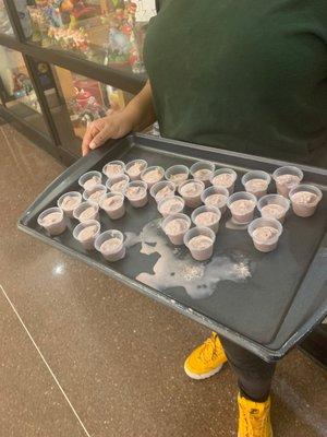 Cherry ice cream samples, being offered outside the store.