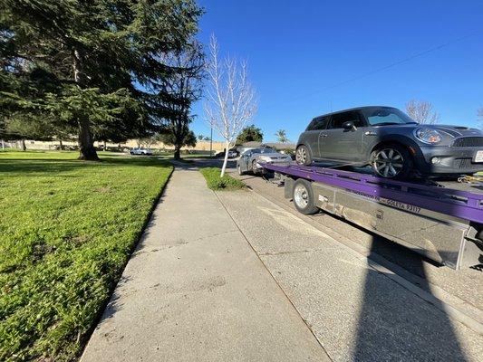 Smittys towing truck loaded with cars parked on Walnut Ln.