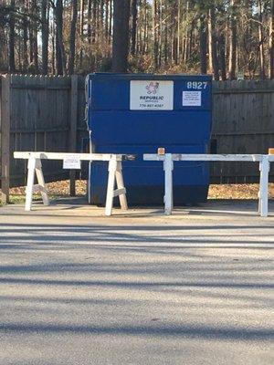 Dumpster - with barriers and signs telling campers not to use.