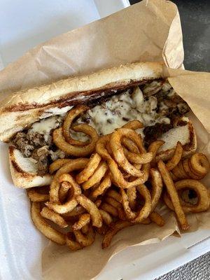 Philly cheese steak w/ provolone cheese and curly fries