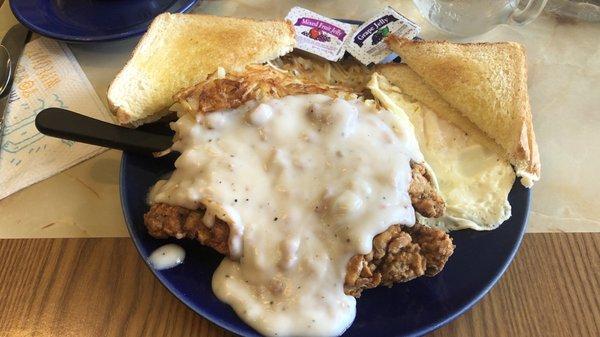 Chicken fried steak breakfast with hash browns and over easy egg