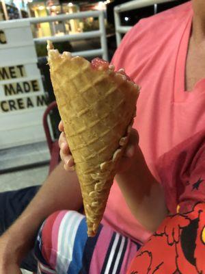 Strawberry sorbet in a waffle cone.