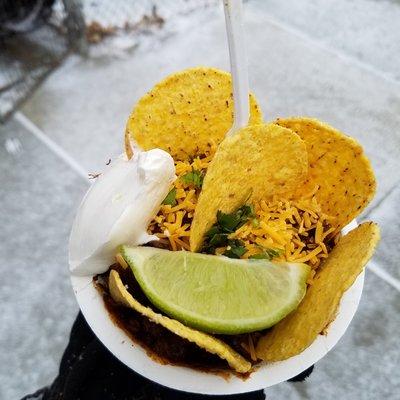 Spicy Chicken Cup: spicy chicken chili on top of rice with tortilla chips, cheese, sour creme and lime