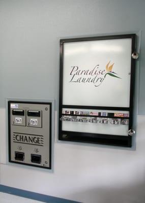 Two Change Machines next to the Soap, Bleach and Fabric Softener dispenser