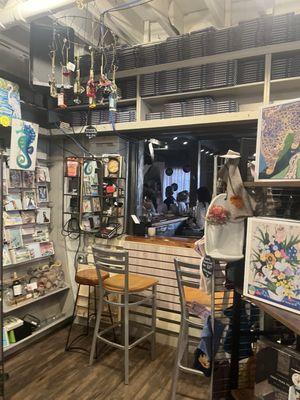 A peak of the bar through the interior of the bookstore