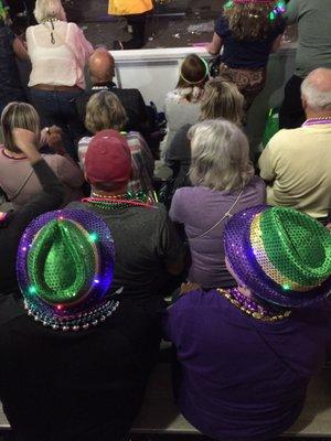 Happy seated people watch the Endymion parade.