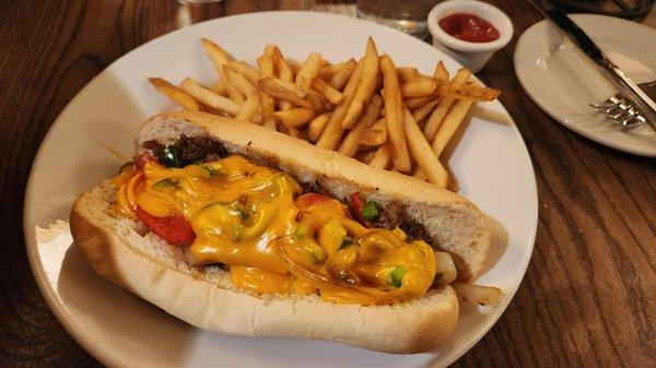 Philly cheesesteak with nacho cheese & fries. Good flavor, tough meat.