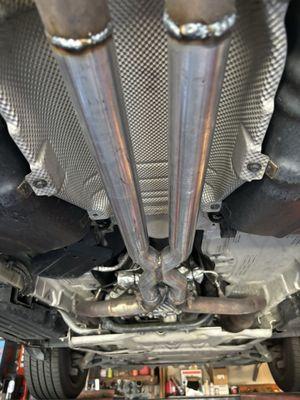 The straight pipes connected to the X pipe.