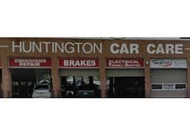 This is a photograph of Huntington Car Care with the garage-type doors of the service bays open.