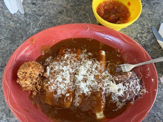 2 cheese enchiladas with dark sauce, rice and beans.