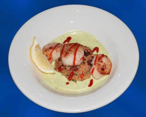 Pan seared Scallops, quinoa/walleye cake, Avocado-cilantro cream and Sriracha