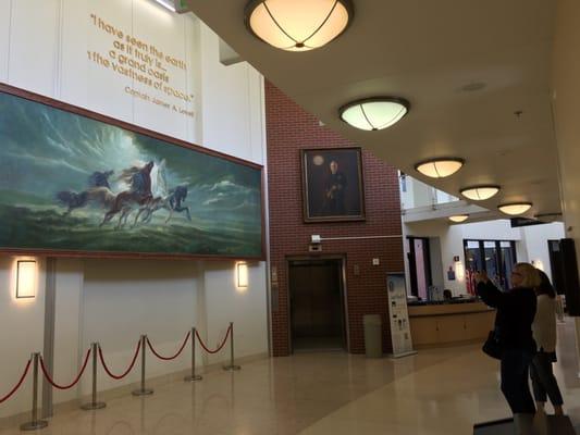 The lobby/hallway of Bldg 133 with Capt. Lovell's portait, quotation, and "Steeds of Apollo" mural