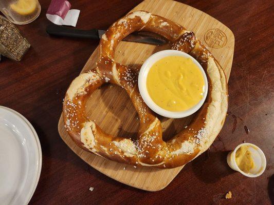 Baked pretzel with cheese.