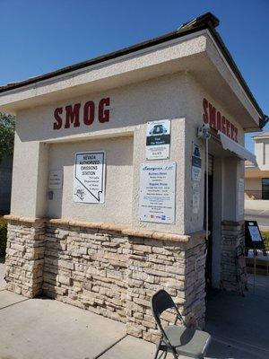 The kiosk where they conduct smog checks. Entrance faces the convenience store of the gas station.