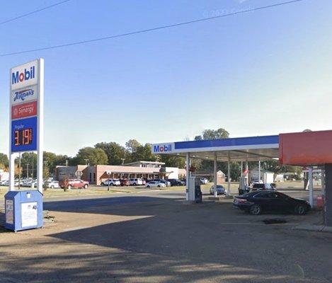 view of gasoline station facility and price sign