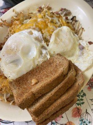 Stuffed hash browns with 2 eggs and toast