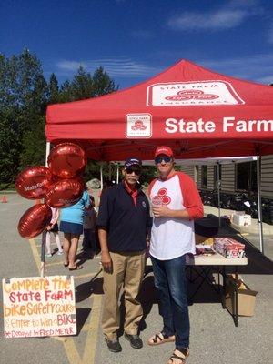 State Farm Agents, Troy Sayer & Al Bowler, partner up to donate helmets and teach bike safety @ the annual State Farm Bicycle Safety Rodeo.