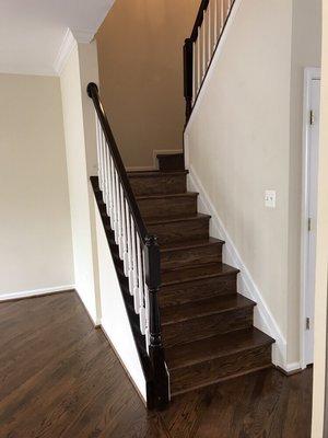 Dark stain floors and French polished handrails.