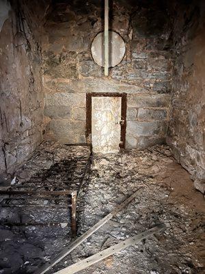 Old destroyed cell - small door to exit into yard