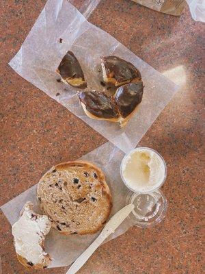 Chocolate donut and blueberry bagel with cream cheese on the side