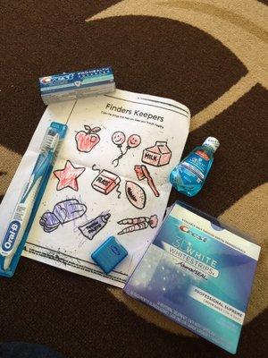 Some of the goodies I received from my cleaning  plus a cute coloring sheet my daughter colored during her check up.