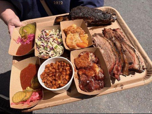 Full meal platter of brisket, ribs, and all sides.