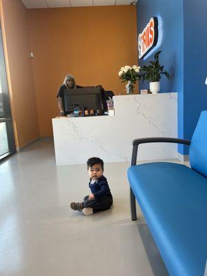 Our son resting on the floor instead of the beautiful blue chairs. Haha.