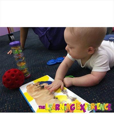 Even our young Infants enjoy reading books. Look at that big dog!