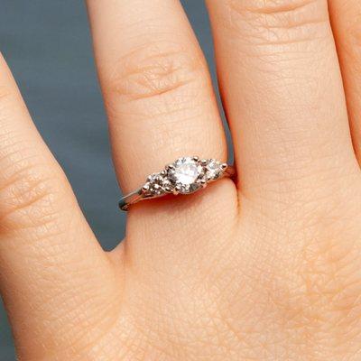 Ring on fiancées hand. It is both delicate and striking, with the stones beautifully balanced in the setting.