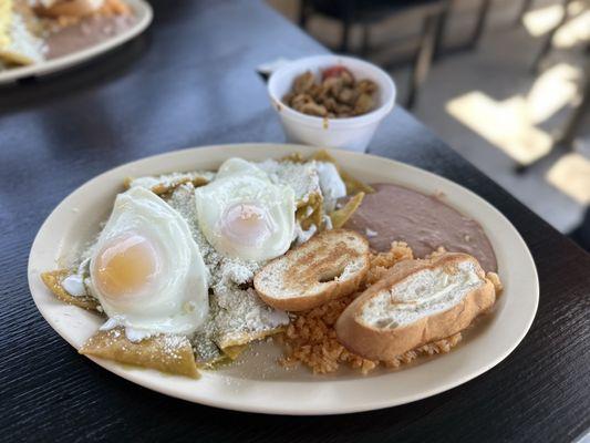 Delicious green chilaquiles with chicken on the side (extremely flavorful, must try!)