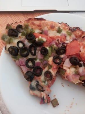 A slice of a small veggie pizza. A+. Thats what a pizza should look like.