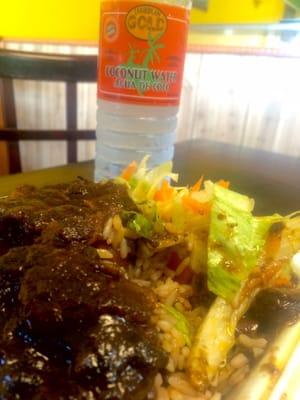 Oxtails, rice and peas, salad and coconut water.