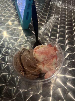 Double scoop in cup with chocolate and strawberry cheesecake