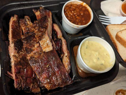 Big rib dinner with potato salad and beans