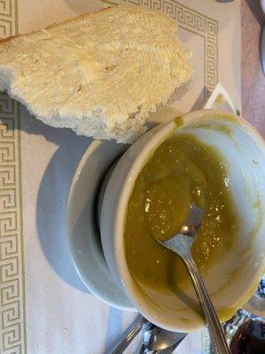 Cup of split pea soup with homemade bread.