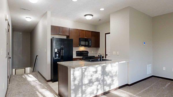 1-bed Fir Villa (#89) - Galley Kitchen with Granite Countertops and Dark Cabinets